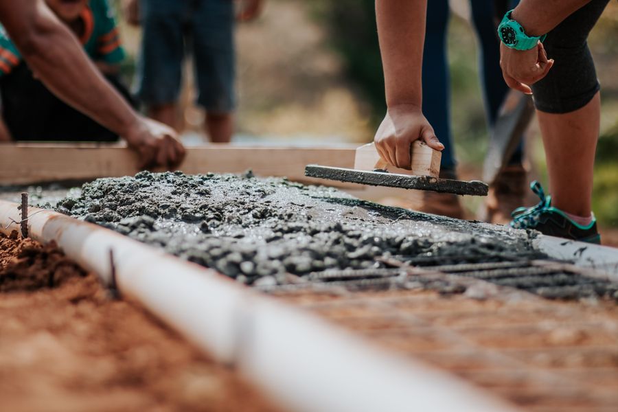 BuildCore crew levelling a freshly poured concrete slab