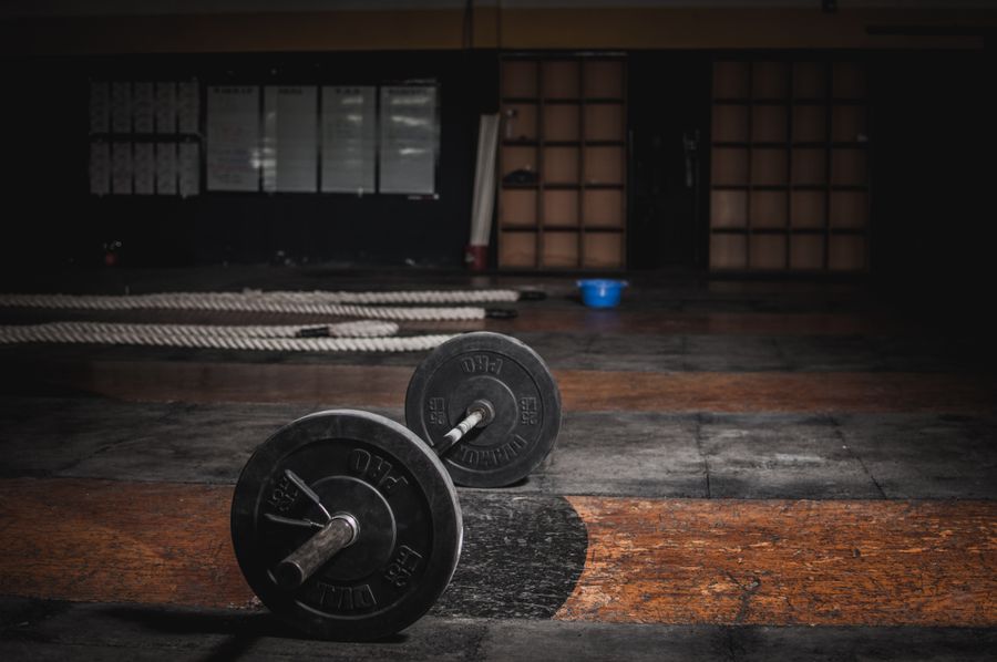 Loaded barbell on the strength floor at Momentum