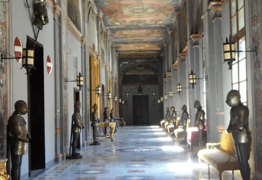 Historic palazzo hallway with painted ceilings and stone arches
